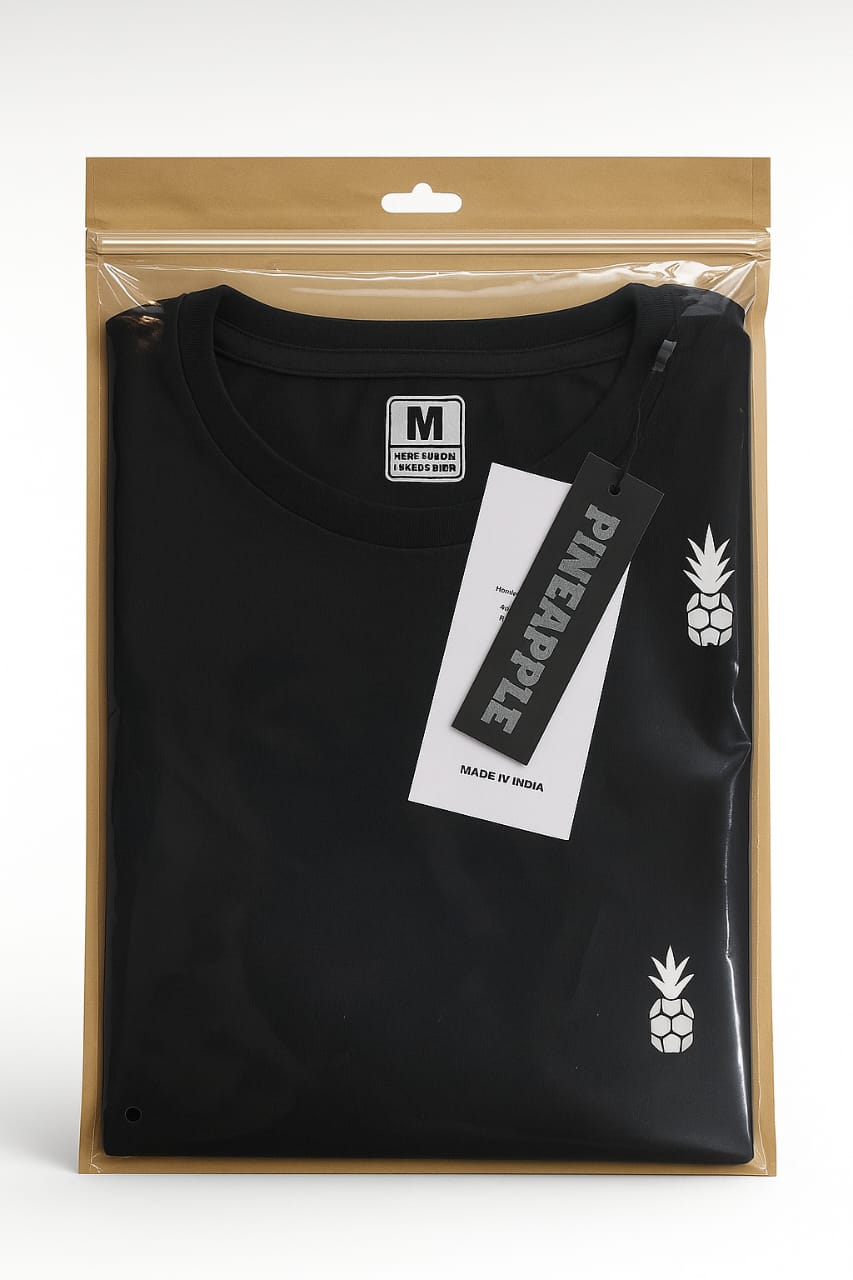 kraft back transparent zipper bag with folded black tshirt and tag – premium garment packaging by paras packing


