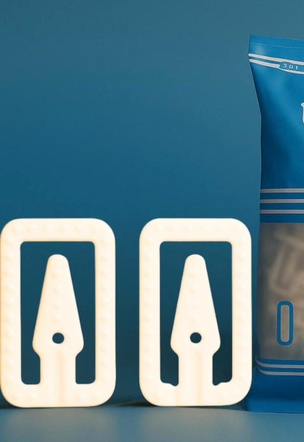 uttam prime m-clip pouch with closeup of two white clips on blue background
